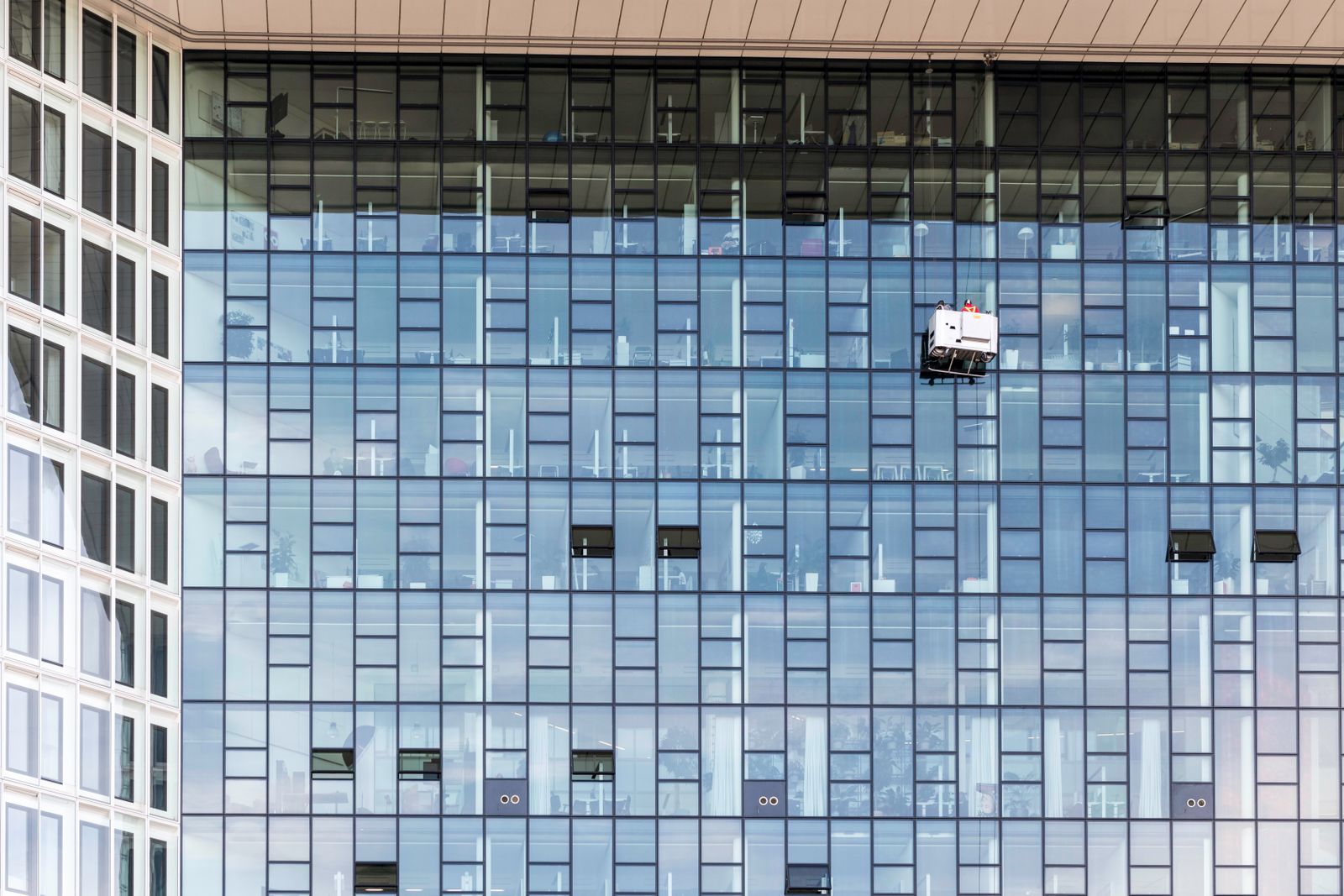 Window cleaners working the exterior glass of a building