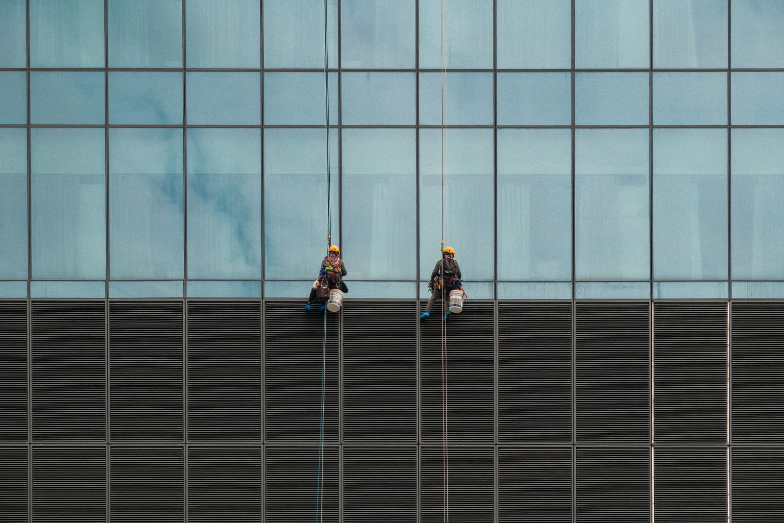 Exterior glass being washed on a building facade